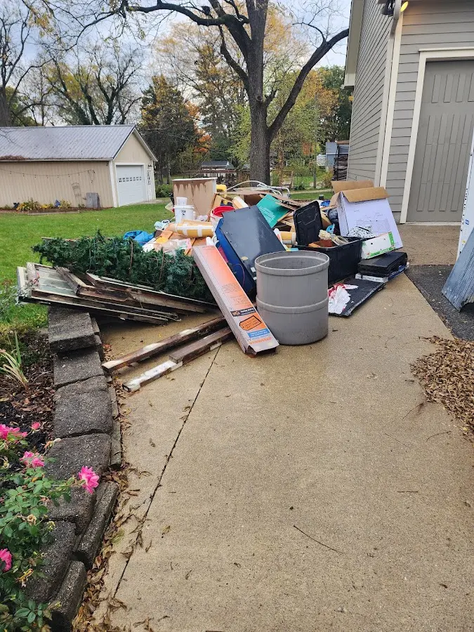 Dumpster being loaded with debris for Estate Cleanout Dumpster Rental in Port Aransas